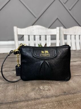 Madison black pebbled leather wristlet featuring gold-tone hardware